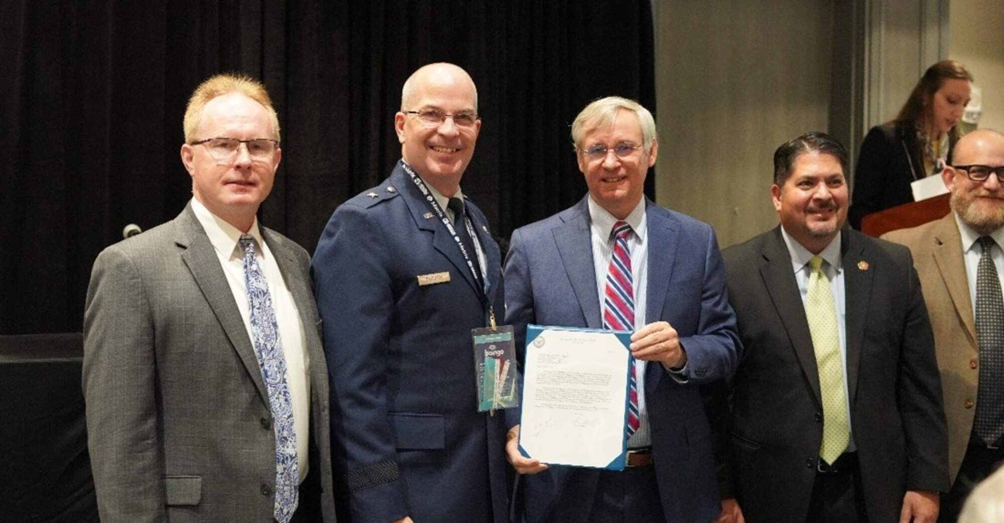 Members of the Electromagnetic Defense Initiative at Joint Base San Antonio, along with Brigadier General Russell D. Driggers, 502nd Air Base Wing Commander (middle-left), and Robert Moriarity, Deputy Assistant Secretary of the Air Force for Installations(middle-right), attended the 2nd Annual Air Force Community Partnership award ceremony at the Association of Defense Community Installation Innovation Forum in Orlando, Florida.
