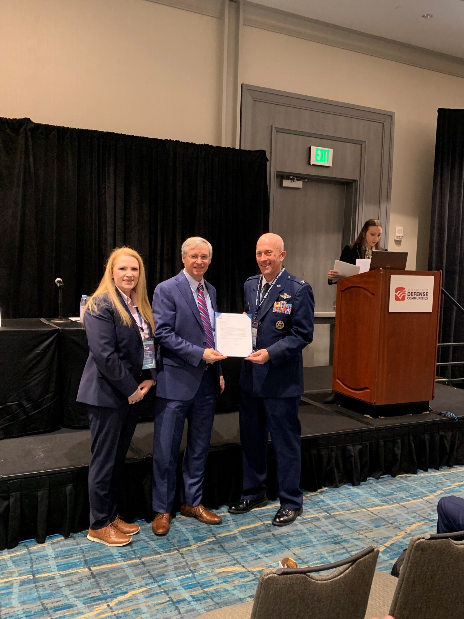 Ms. Paige Dukes, Lowndes County Manager (left), and Colonel Michael Gallagher, 23d Mission Support Group Commander (right), receiving the Air Force Community Partnership award to Moody Air Force Base for partnership with Lowndes County for operation of Quiet Pines Golf Course.