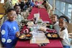 Family eating a holiday meal at a hospital cafeteria.