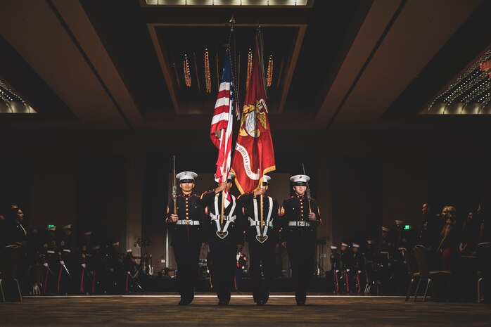 U.S. Marine Corps Cpl. Elliott Flood-Johnson, a combat videographer with Marine Corps Recruit Depot San Diego, marches on the cake during a birthday ball ceremony in San Diego, Nov. 10, 2023. A celebration of the 248th Marine Corps birthday was held to reflect on the traditions, history and legacy of the Marine Corps. Flood-Johnson is a native of Minot, North Dakota. (U.S. Marine Corps photo by Sgt. Yvonna Guyette)