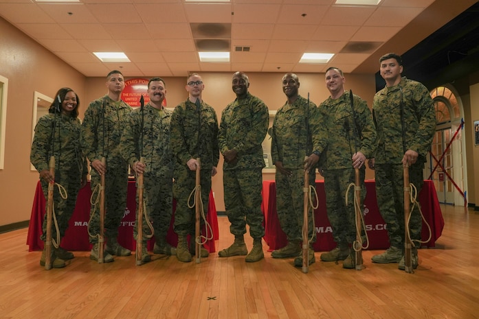 U.S. Marines with Western Recruiting Region, pose for a photo with Brig. Gen. James A. Ryans II (center), commanding general of Marine Corps Recruit Depot San Diego and Western Recruiting Region, after receiving awards during a Neptune Award ceremony at MCRD SD, Nov. 16, 2023. The Neptune awards, presented to deserving recruiters in the Western Recruiting Region, aim to incentivize effort, instill confidence, and recognize advancement in contract writing proficiency enhancing the region’s collective recruiting outcomes. (U.S. Marine Corps photo by Lance Cpl. Janell B. Alvarez)