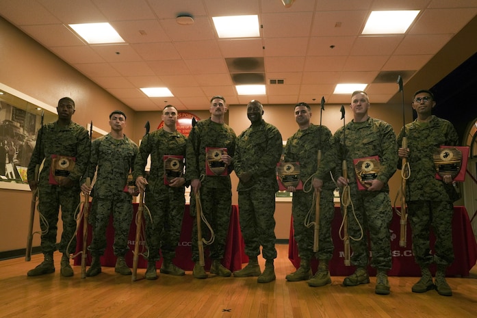 U.S. Marines with Western Recruiting Region, pose for a photo with Brig. Gen. James A. Ryans II (center), commanding general of Marine Corps Recruit Depot San Diego and Western Recruiting Region, after receiving awards during a Neptune Award ceremony at MCRD SD, Nov. 16, 2023. The Neptune awards, presented to deserving recruiters in the Western Recruiting Region, aim to incentivize effort, instill confidence, and recognize advancement in contract writing proficiency enhancing the region's collective recruiting outcomes. (U.S. Marine Corps photo by Lance Cpl. Janell B. Alvarez)
