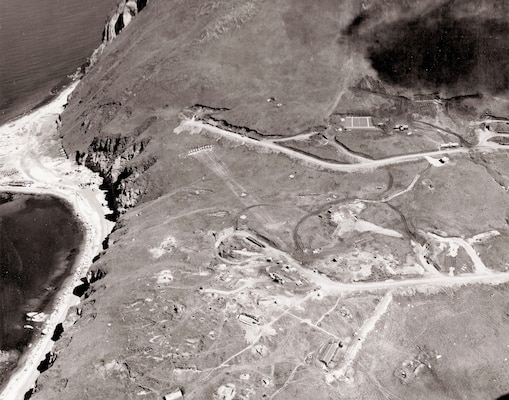 An aerial view of Dutch Harbor Naval Air Station on July 21, 1943, reveals a runway and other key features of the remote area’s abundant military construction.
