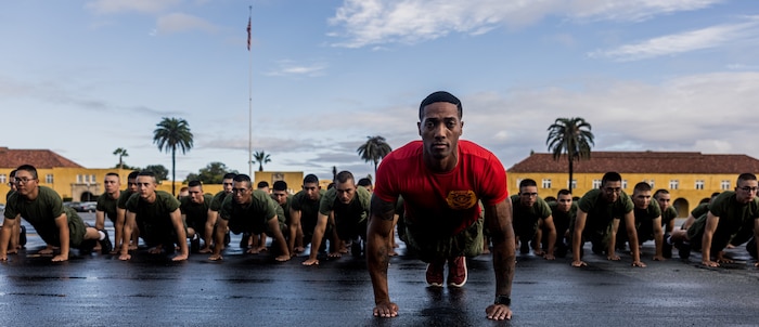 New U.S. Marines with Alpha Company, 1st Recruit Training Battalion, execute Marine Corps push-ups during a motivational run at Marine Corps Recruit Depot San Diego, Nov. 16, 2023. The motivational run is the final training event the Marines complete before graduating and consists of a three-mile run throughout the Depot. (U.S. Marine Corps photo by Lance Cpl. Jacob B. Hutchinson)