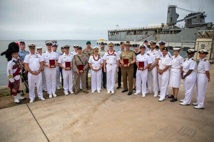 NUKU’ALOFA, Tonga (Nov. 20, 2023) – Representatives of the Royal Navy, Royal Australian Navy, Royal New Zealand Navy, Royal Canadian Navy and the U.S. Navy pose for a group photo after the closing ceremony of the Pacific Partnership 2023 Tonga mission stop in front of Harpers Ferry-class dock landing ship USS Pearl Harbor (LSD 52), Nov. 20.  Now in its 18th year, Pacific Partnership is the largest annual multinational humanitarian assistance and disaster relief preparedness mission conducted in the Indo-Pacific. (U.S. Navy photo by Mass Communication Specialist 2nd Class Megan Alexander)