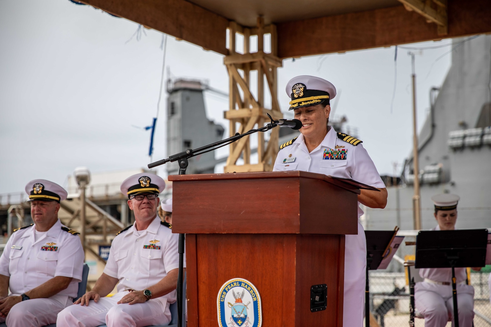 NUKU’ALOFA, Tonga (Nov. 20, 2023) – Capt. Claudine Caluori, mission commander of Pacific Partnership 2023, speaks during the Pacific Partnership 2023 Tonga closing ceremony in front of Harpers Ferry-class dock landing ship USS Pearl Harbor (LSD 52), Nov. 20.  Now in its 18th year, Pacific Partnership is the largest annual multinational humanitarian assistance and disaster relief preparedness mission conducted in the Indo-Pacific. (U.S. Navy photo by Mass Communication Specialist 2nd Class Megan Alexander)