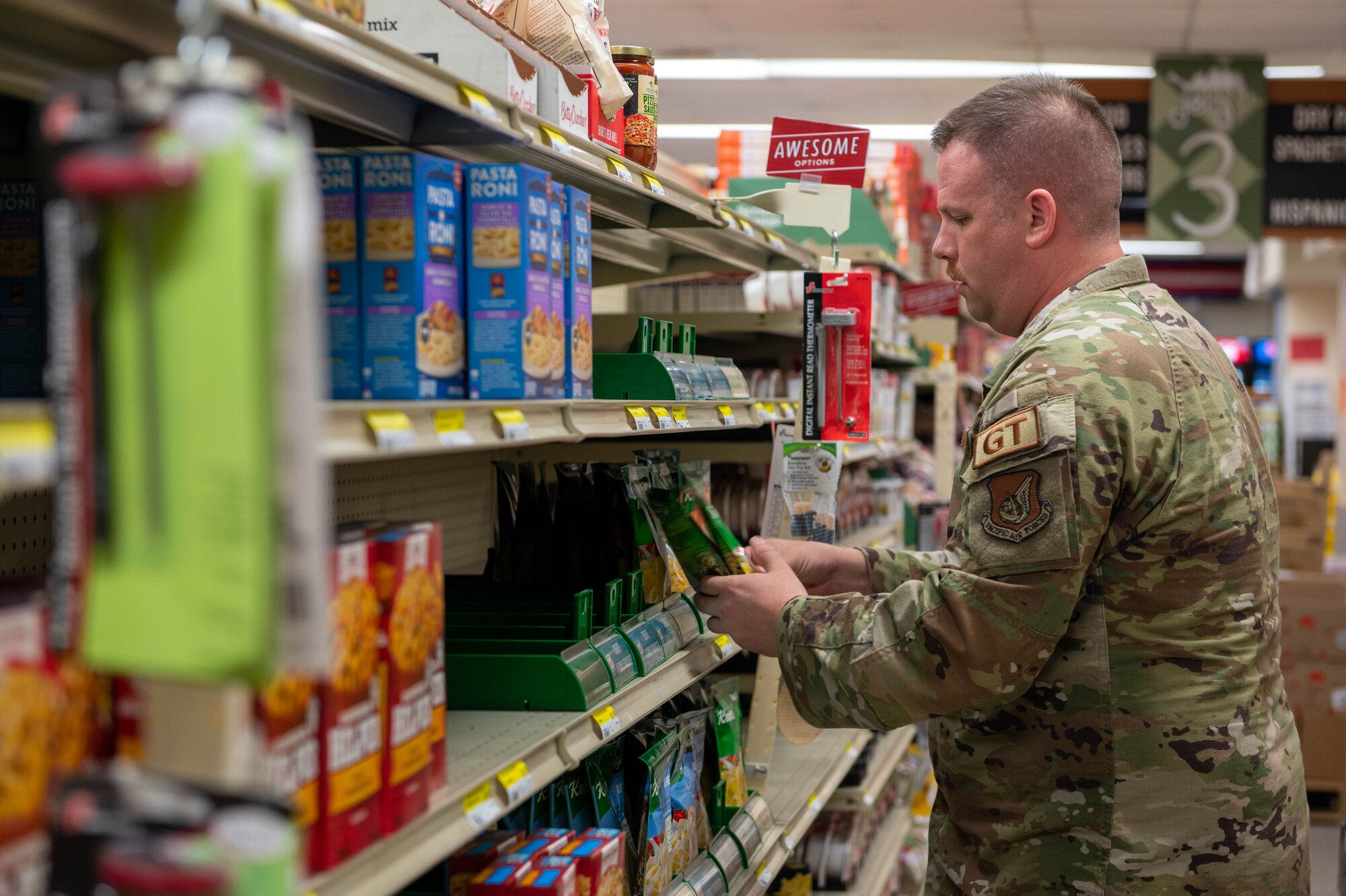 U.S. Air Force Tech. Sgt. Johnathan Oliver, 36th Logistic Readiness Squadron quality assurance, helps stock the shelves in the commissary at Andersen Air Force Base, Guam, Nov. 18, 2023.