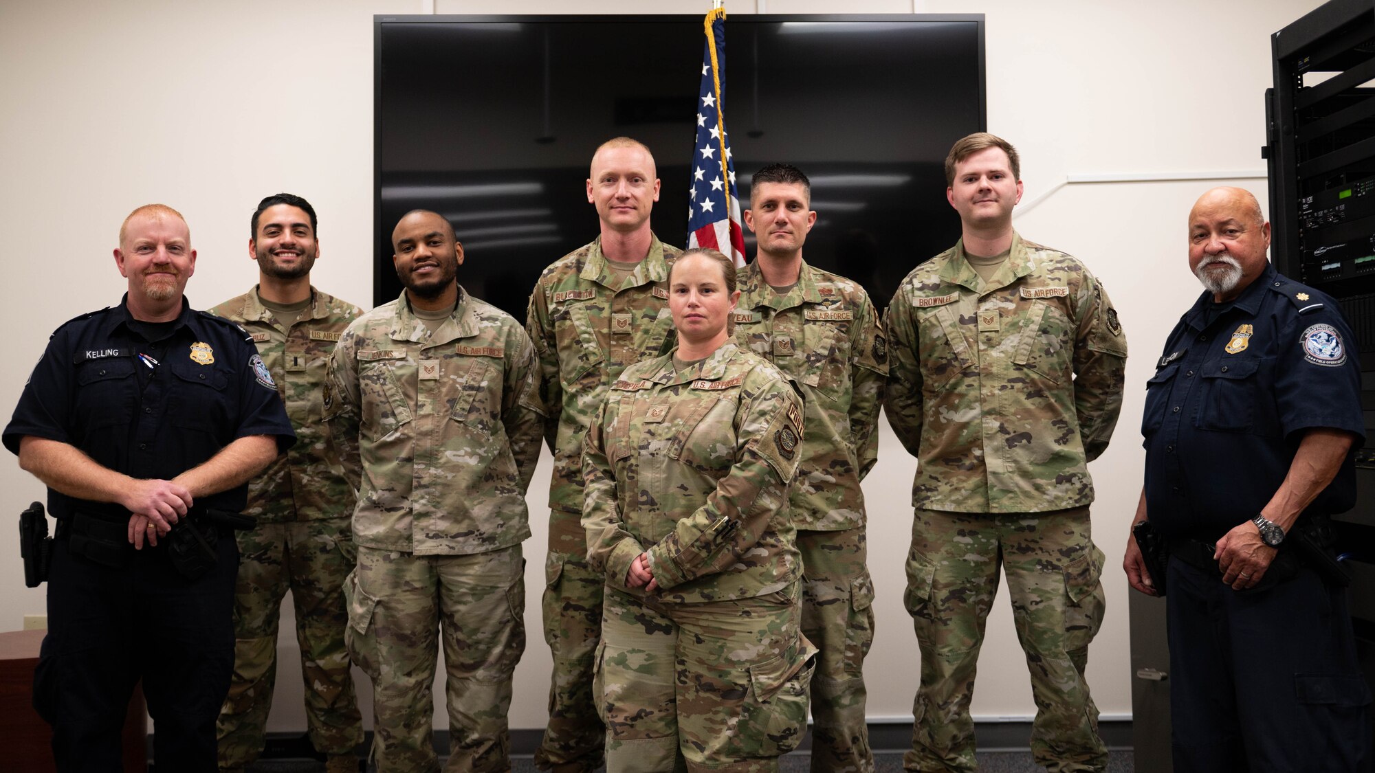 436th Mission Generation Group Airmen and U.S. Customs and Border Protection officers pose for a group after a Military Customs Officer–Excepted program graduation at Dover Air Force Base, Delaware, Nov. 7, 2023. The Military Customs Officer–Excepted (MCO-E) program training entails eight hours of classroom and hands-on on-the-job training, that allows the military customs officers to clear arriving active U.S. military crew and their cargo.(U.S. Air Force photo by Tech. Sgt. J.D. Strong II)
