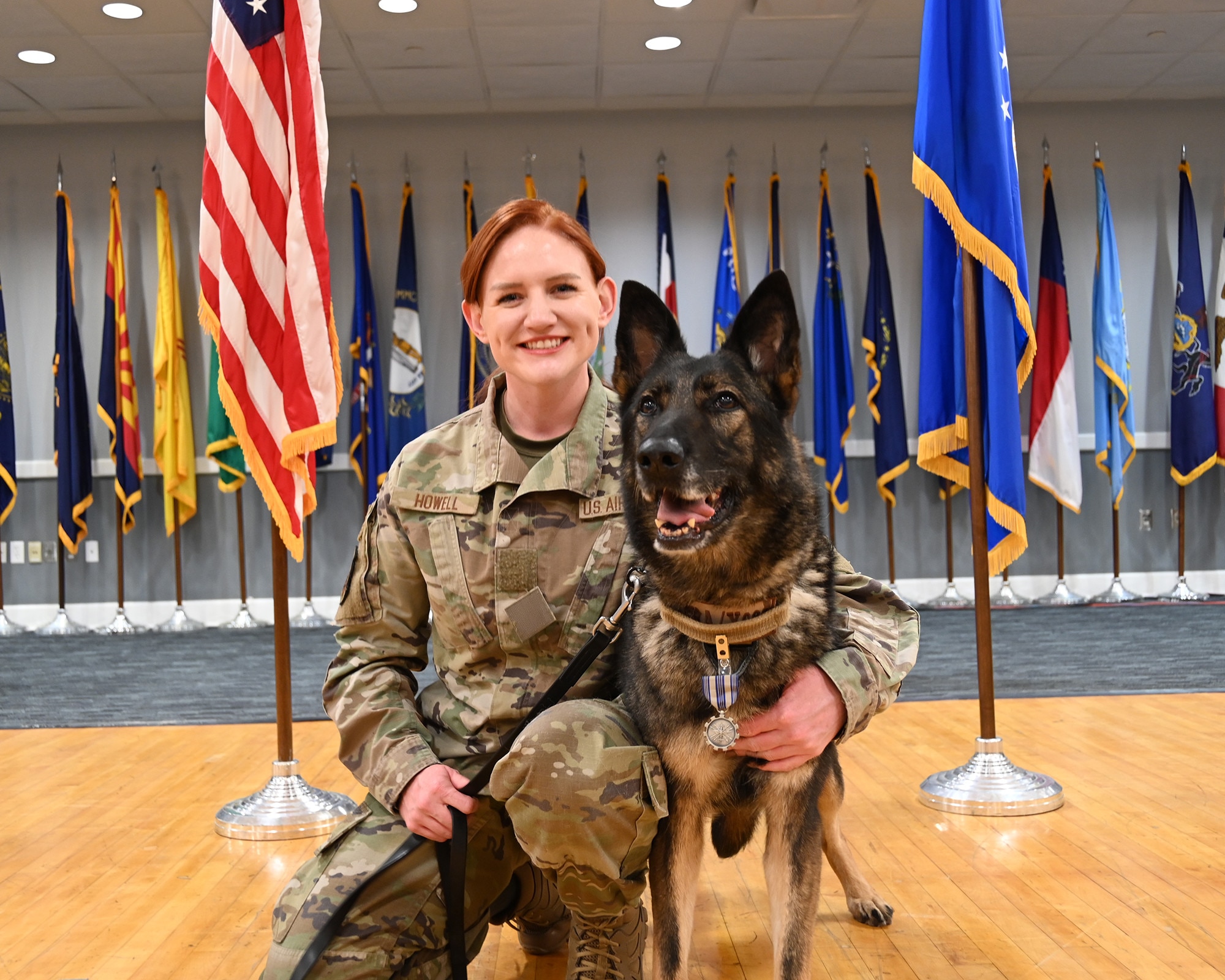 Security Forces Handler and K-9 pose for photo.