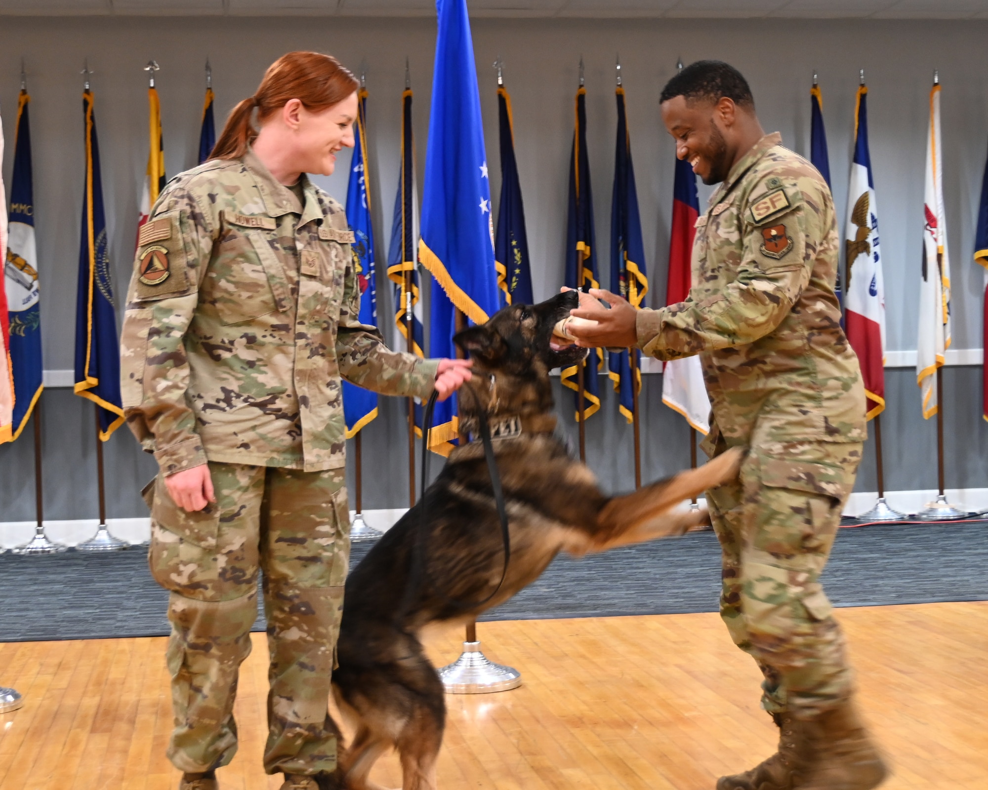 Security Forces Handlers award K-9 with a bone.