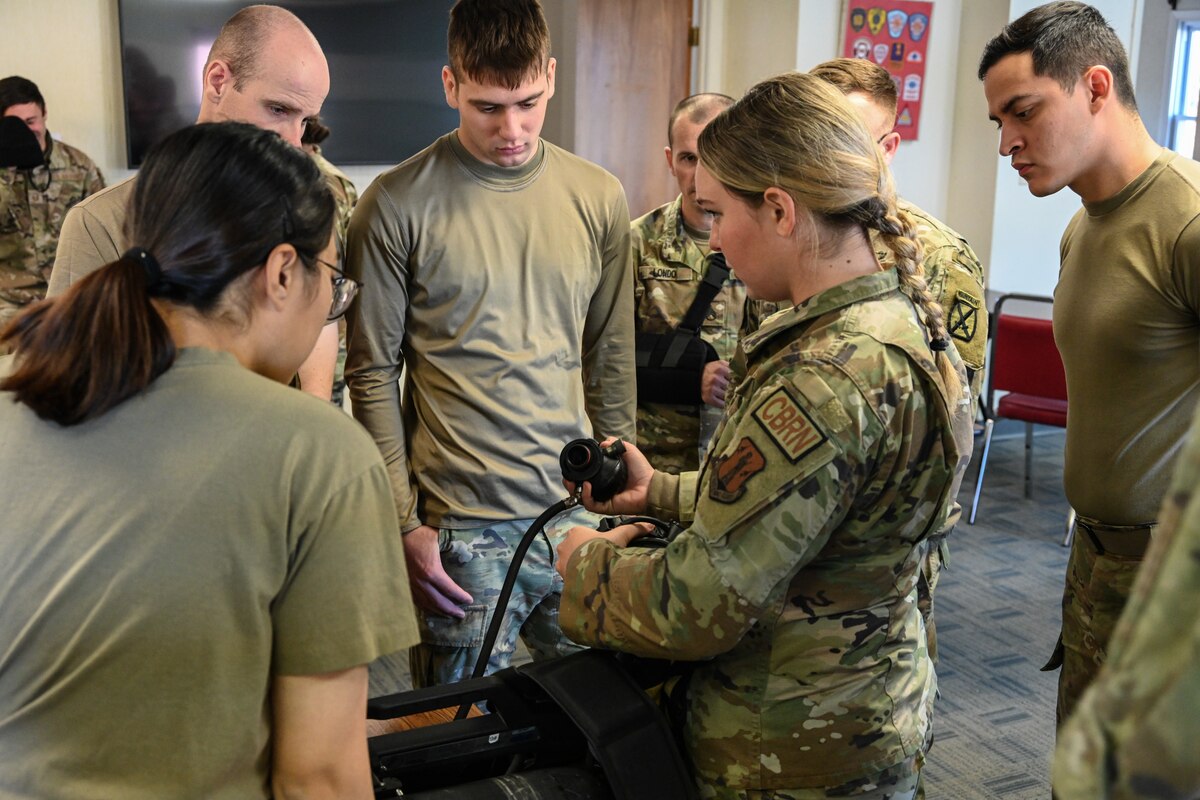 Senior Airman Karlie Foster, 2nd Civil Support Team, New York National Guard, trains Soldiers from the Dismounted Chemical Reconnaissance Platoon of the 10th Mountain Division how to use oxygen masks during a training exercise at the Colonie Fire Training Center in Latham, New York, Nov 17, 2023.