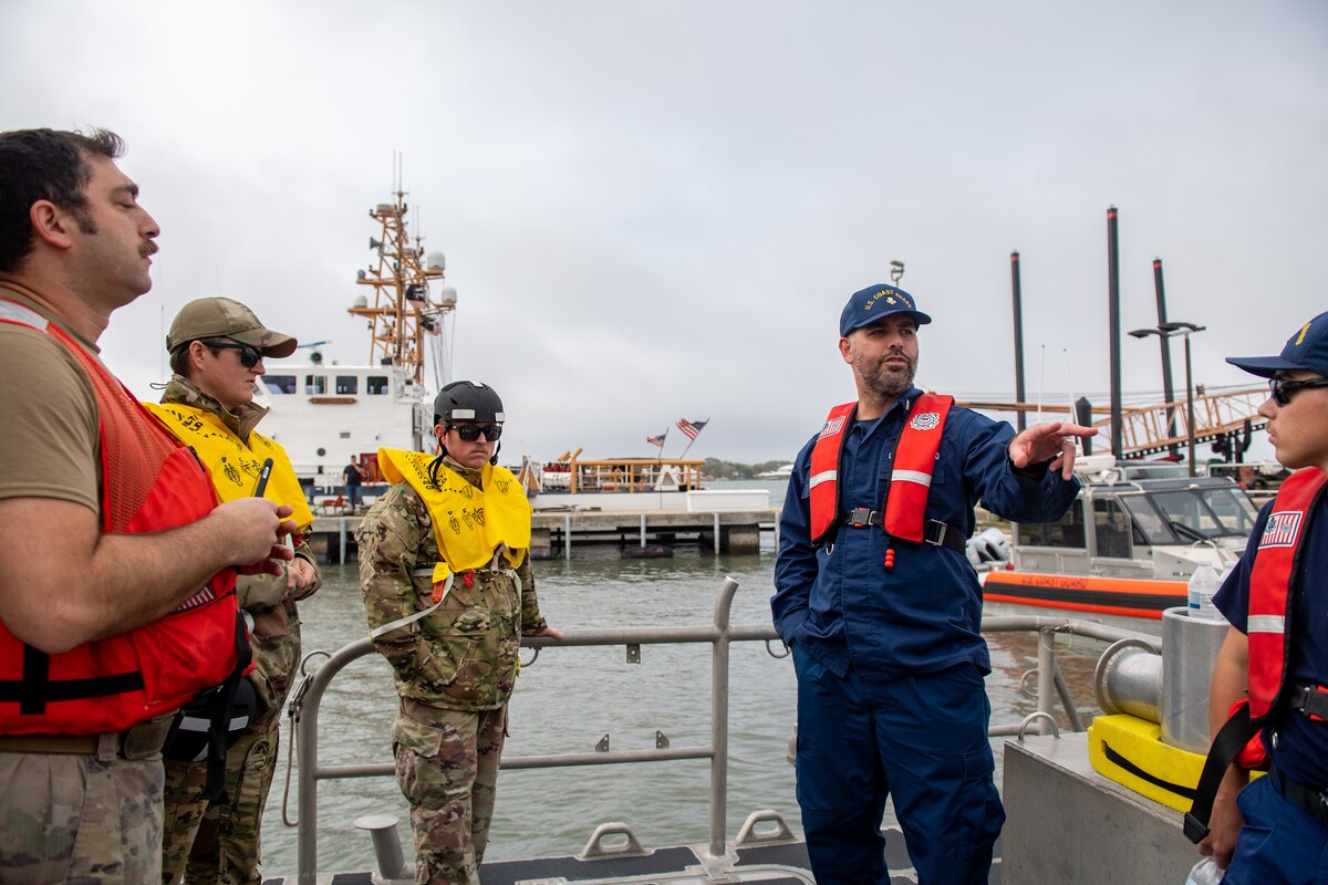 U.S. Coast Guard Petty Officer 1st Class Tim Mathis, USCG STA Mayport unit supervisor, gives a safety brief before a simulated joint team rescue with U.S. Air Force Airmen during Mosaic Tiger 24-1 off the coast of Jacksonville on Nov. 17, 2023. Joint training exercises ensure preparedness for global personnel recovery. (U.S. Air Force photo by Senior Airman Courtney Sebastianelli)
