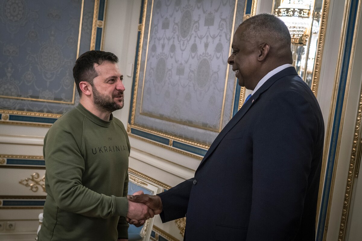 Two men shake hands.