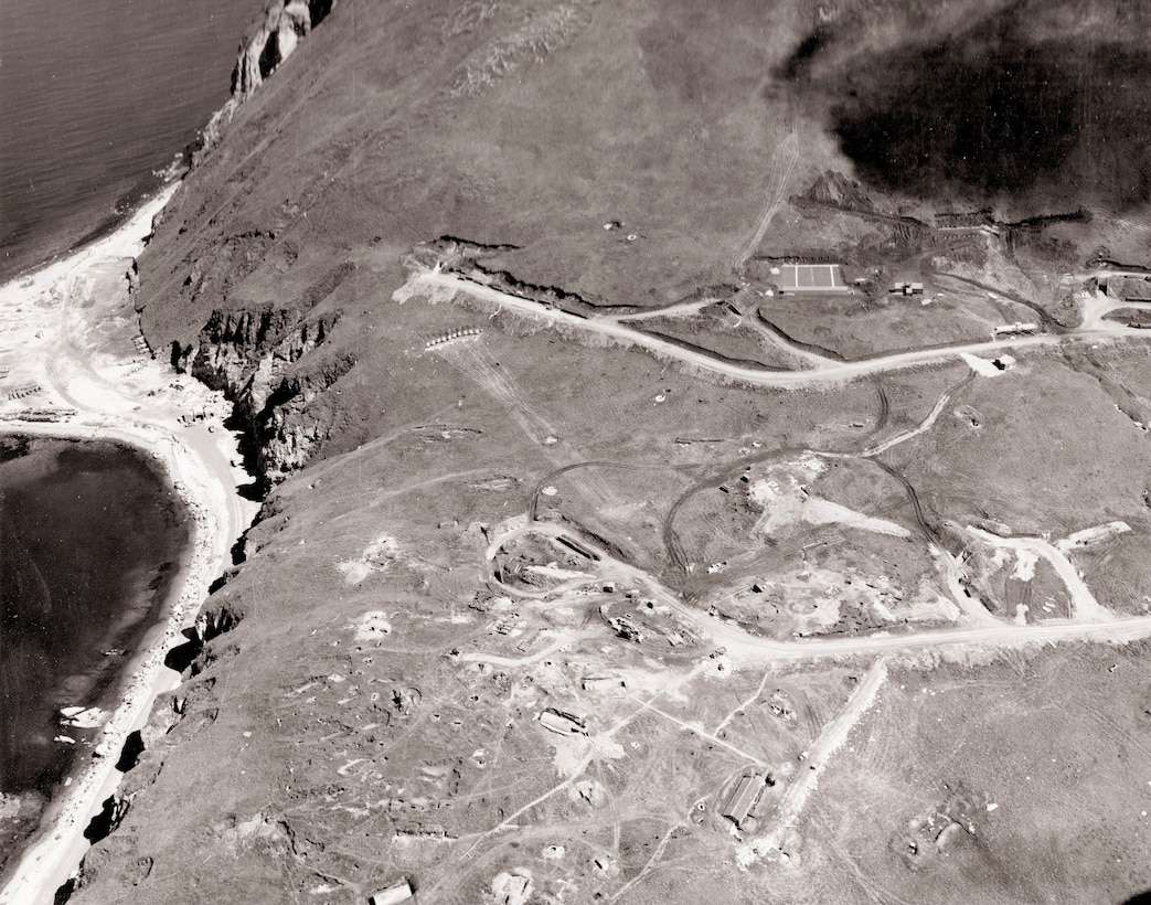 An aerial view of Dutch Harbor Naval Air Station on July 21, 1943, reveals a runway and other key features of the remote area’s abundant military construction.