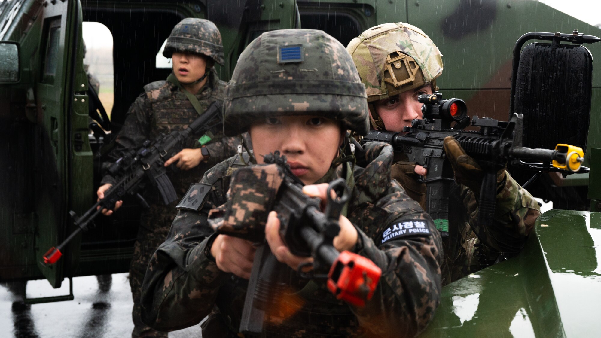 Republic of Korea Air Force Senior Airman Kim Si Hungcu and U.S. Air Force Senior Airman James Boyter hold a defensive position during an anti-terrorism response exercise.