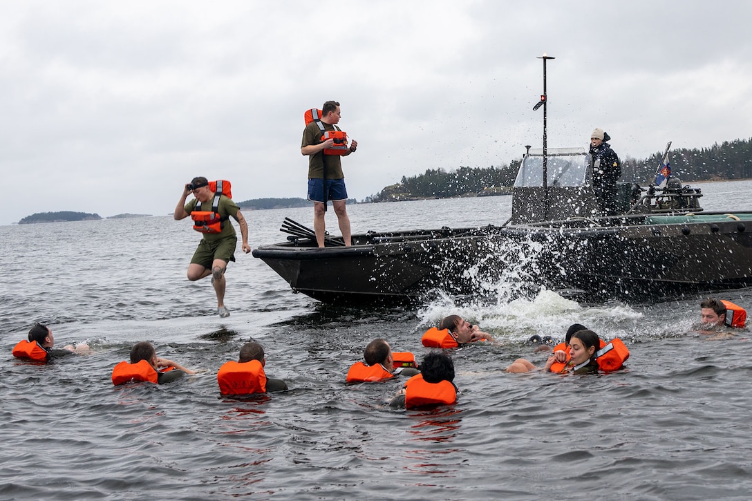 Marines abandon ship during a man overboard drill.