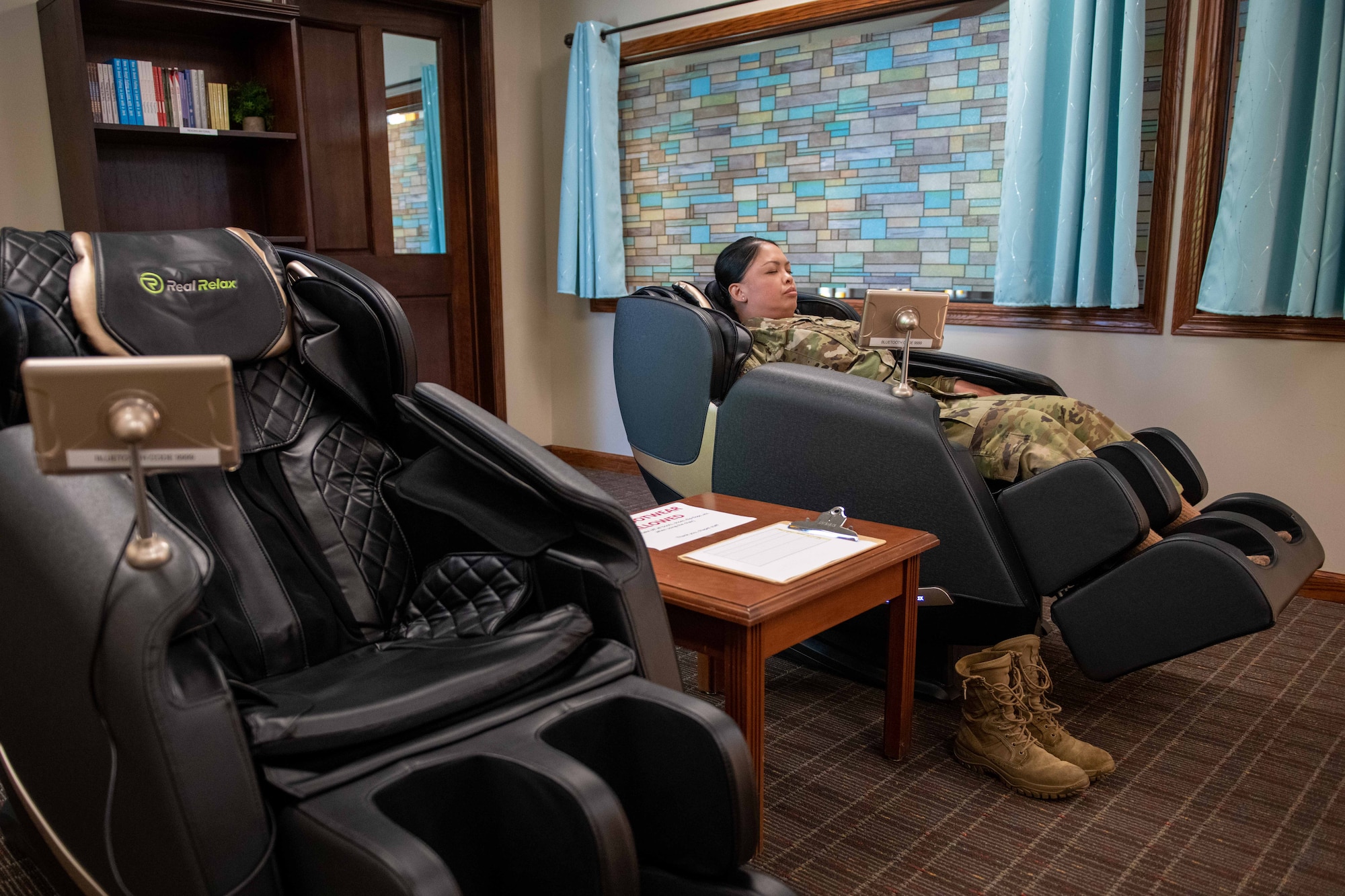 Master Sgt. Tammy Aguero, 22nd Air Refueling Wing chapel volunteer, relaxes in a massager in the new resiliency room at the base Chapel Sep. 7,2023, at McConnell Air Force Base, Kansas. This space serves as a dedicated area for Airmen to relax, de-stress, and rebuild internal strength, ensuring they can effectively accomplish the mission. (U.S. Air Force photo by Staff Sgt. Adam Goodly)
