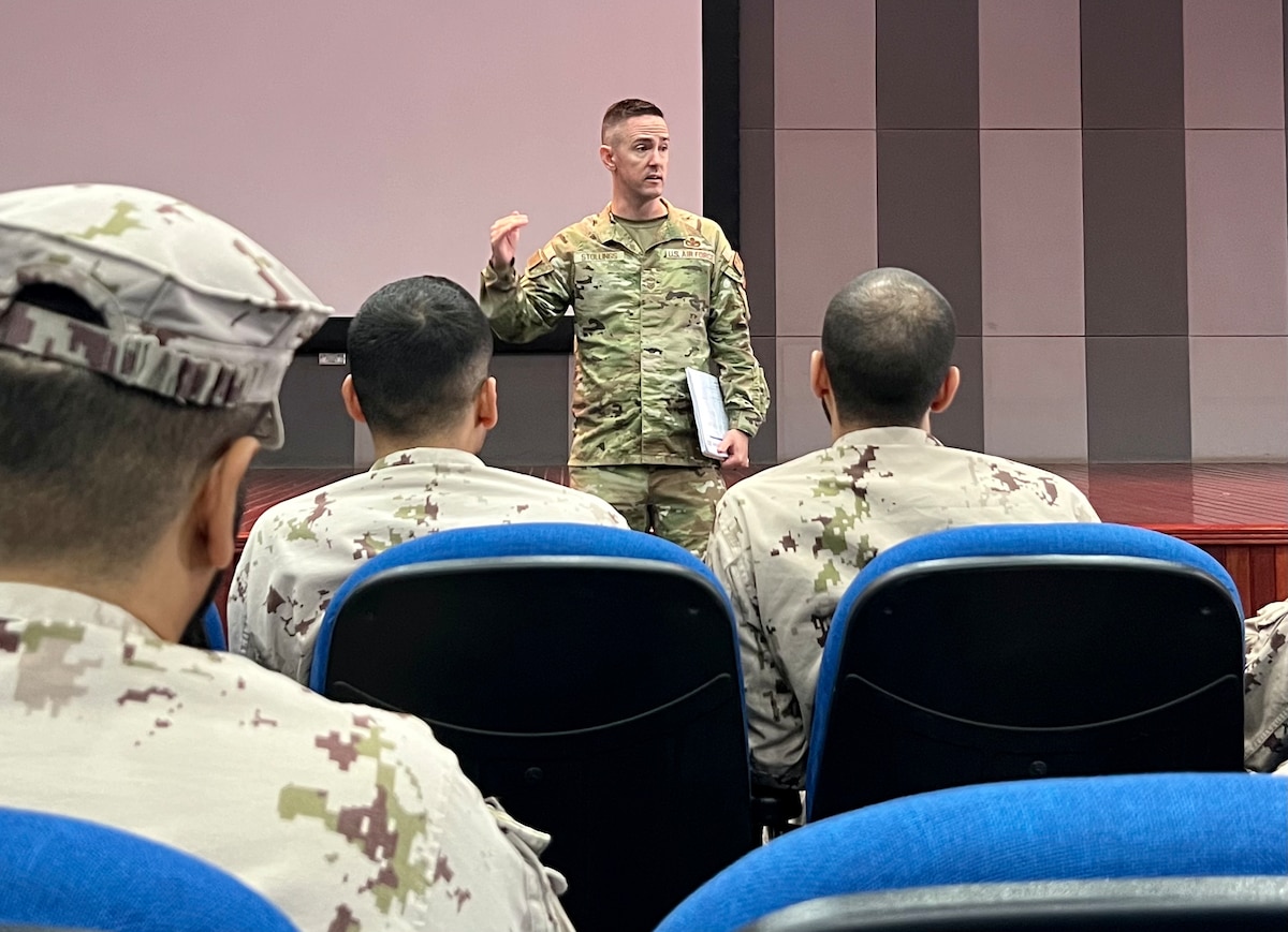 Senior Master Sgt. Cody E. Stollings, Senior Noncommissioned Officer Academy instructor, talks with United Arab Emirates Air Force students during a professional military education class in the UAE, Oct. 13, 2023. Five BCEE instructors traveled to the UAE to deliver the noncommissioned officer leadership PME, Oct. 2 to Oct. 28, 2023. (Courtesy photo)