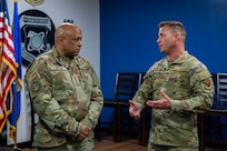 Senior Master Sgt. Brett Mapston, a member of the Air Force Technical Applications Center at Patrick Space Force Base, Fla., briefs Gen. Anthony J. Cotton commander of U.S. Strategic Command, about AFTAC’s 70+ year history of long range detection and nuclear deterrence operations.  Cotton visited the Department of Defense’s sole nuclear treaty monitoring center Nov. 16, 2023, accompanied by USSTRATCOM’s Command Senior Enlisted Leader Sgt. Maj. Howard Kreamer and his Director of Global Operations Maj. Gen. John J. Nichols.   (U.S. Air Force photo by Matthew S. Jurgens)