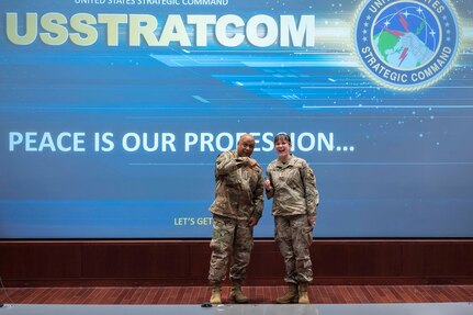 2nd Lt. Piper Gray, a radiochemistry instrumentation lead at the U.S. Air Force Radiochemistry Lab, Patrick Space Force Base, Fla., smiles as she receives a coin from Gen. Anthony J. Cotton, commander of U.S. Strategic Command, during his visit to the Air Force Technical Applications Center Nov. 16, 2023.  Gray was one of six individuals who were presented with the unified combatant commander’s coin for superior service.  (U.S. Air Force photo by Susan A. Romano)