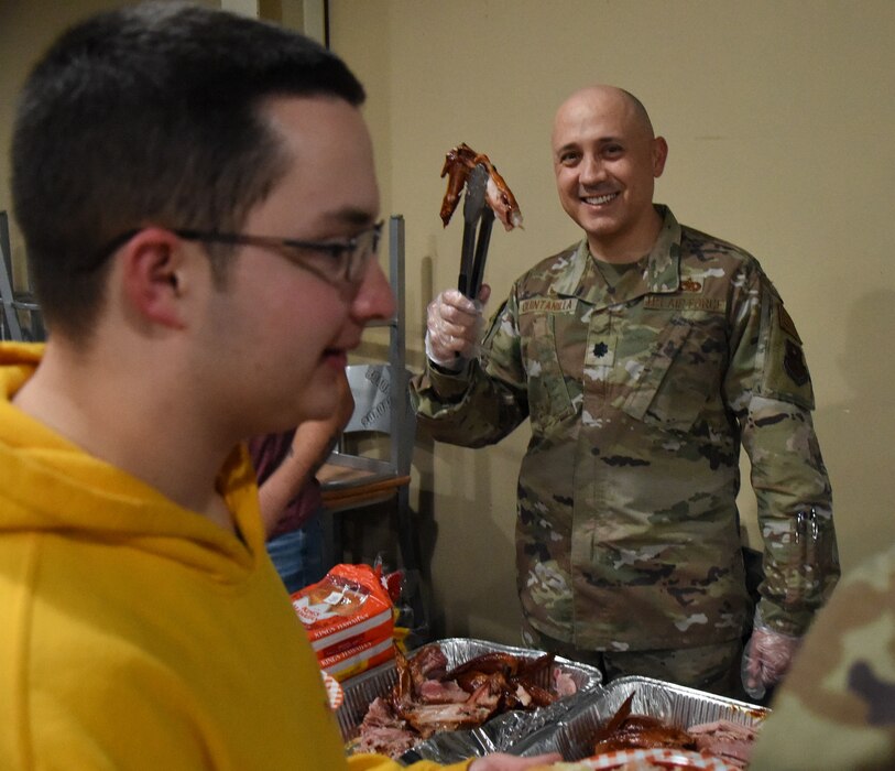 U.S. Air Force Lt. Col. Jose Quintanilla, 17th Logistical Readiness Squadron commander, serves turkey to students at the Crossroads Thanksgiving event, Goodfellow Air Force Base, Texas, Nov. 17, 2023. Service members from every branch of the military were present to receive a Thanksgiving dinner provided by volunteers from the military and surrounding community. (U.S. Air Force Photo by Staff Sgt. Nathan Call)