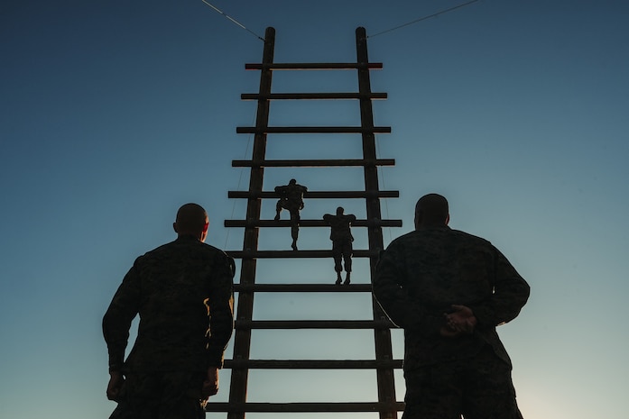 U.S. Marine Corps students with Marine Corps Recruit Depot San Diego Drill Instructor School, Recruit Training Regiment, participate in the “stairway to heaven” during the confidence course at MCRD San Diego, California, Nov. 14, 2023. Drill instructor school further develops the leadership, command presence, instructional ability, physical fitness, and knowledge of selected officers, staff noncommissioned and noncommissioned officers in order to successfully perform the duties of a series commander and drill instructor. (U.S. Marine Corps photo by Lance Cpl. Francisco Angel)