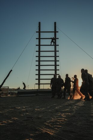 U.S. Marine Corps students with Marine Corps Recruit Depot San Diego Drill Instructor School, Recruit Training Regiment, participate in the “stairway to heaven” during the confidence course at Marine Corps Recruit Depot San Diego, California, Nov. 14, 2023. Drill instructor school further develops the leadership, command presence, instructional ability, physical fitness, and knowledge of selected officers, staff noncommissioned and noncommissioned officers in order to successfully perform the duties of a series commander and drill instructor. (U.S. Marine Corps photo by Lance Cpl. Francisco Angel)