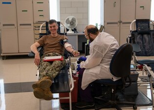 Capt. Kenneth J. Froberg, Commanding Officer, Recruit Training Command (RTC) donates blood as part of the Armed Services Blood Program (ASBP) Nov. 15.  More than 40,000 recruits train annually at the Navy’s only boot camp. (U.S. Navy photo by Mass Communication Specialist 2nd Class Stuart Posada)