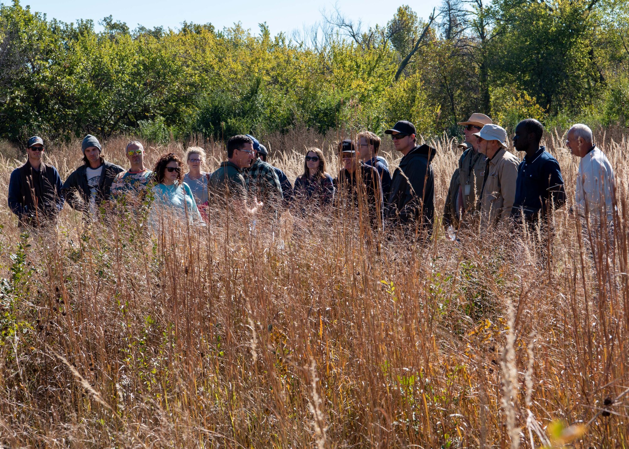 Attendees viewing a prairie restoration area during a workshop.