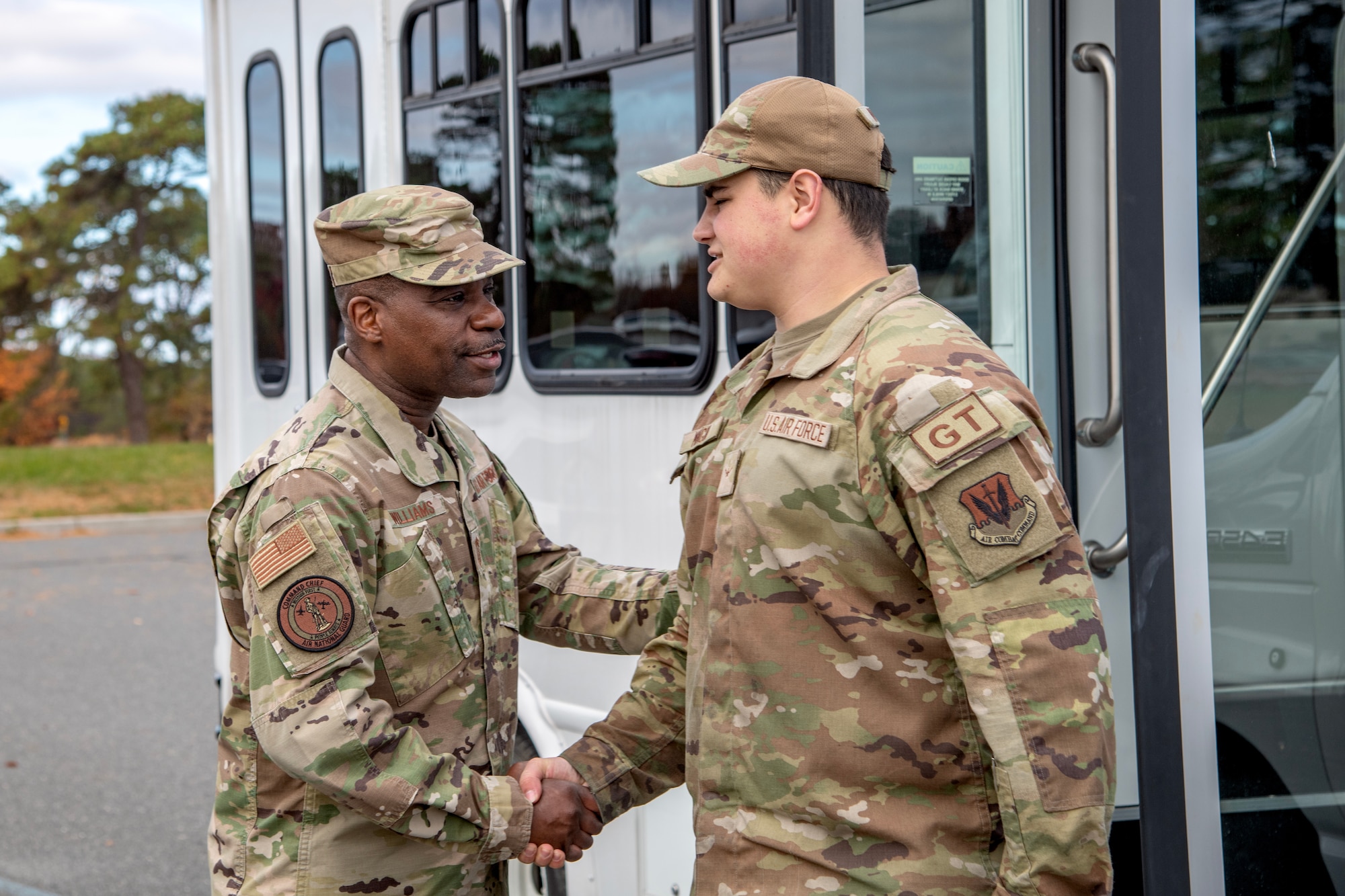A photo of Chief Master Sgt. Maurice L. Williams shaking the hand of Airman Gavin Mingin.