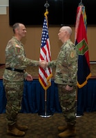 U.S. Army Col. Richard West, the 1st Infantry Division Chaplain assigned to 1st Infantry Division Artillery, 1st Infantry Division, and Maj. Gen. John V. Meyer III, commanding general of the 1st Inf. Div. and Fort Riley, shake hands during West’s promotion ceremony on Nov. 9, 2023, at Victory Hall on Fort Riley, Kansas. West recited the oath of office to extend his time in service. (U.S. Army photo by Pfc. Autumn Johnson)