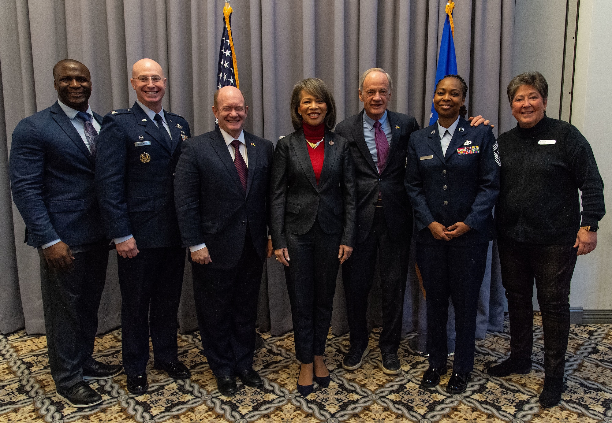 U.S. Air Force Col. Chris McDonald, 436th Airlift Wing commander, second from left, and Chief Master Sgt. Carolyn Russell, 436th AW command chief, second from right, stand with U.S. congressional delegates from Delaware as well as Central Delaware Chamber of Commerce members, at the 2023 State of the Base briefing on Dover Air Force Base, Delaware, Nov. 20, 2023. The event was hosted by the CDCC and informed attendees on community partnership initiatives and the impact that Team Dover has on the state and local economies. (U.S. Air Force photo by Roland Balik)
