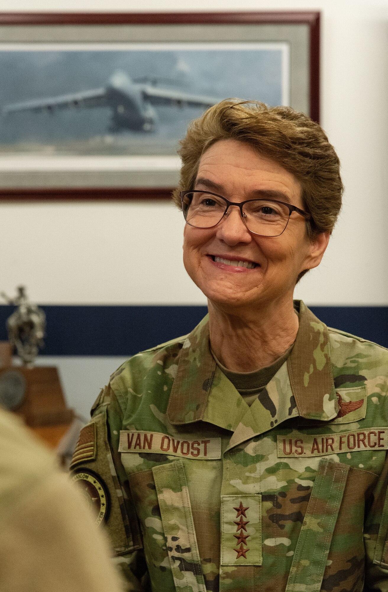 U.S. Air Force Gen. Jacqueline Van Ovost, U.S. Transportation Command commander, listens to a Team Dover member inside the 9th Airlift Squadron’s heritage room during her visit at Dover Air Force Base, Delaware, Nov. 16, 2023. Van Ovost visited Dover to thank Airmen for their hard work and dedication to amplifying TRANSCOM’s mission. (U.S. Air Force photo by Roland Balik)