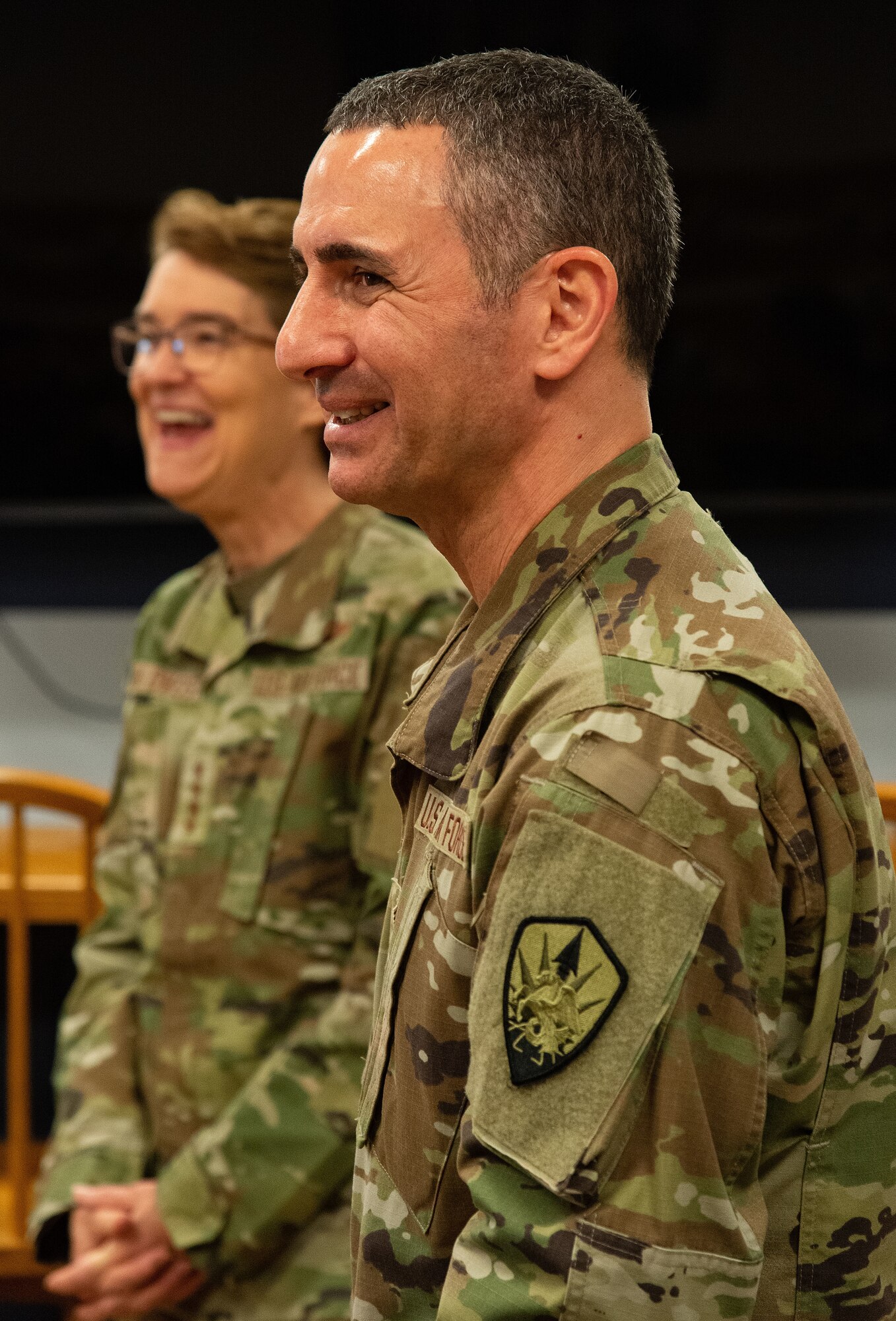 U.S. Air Force Chief Master Sgt. Brian Kruzelnick, foreground, U.S. Transportation Command’s command senior enlisted leader, and U.S. Air Force Gen. Jacqueline Van Ovost, USTRANSCOM commander, share a light moment while visiting with Team Dover members inside the 9th Airlift Squadron’s heritage room at Dover Air Force Base, Delaware, Nov. 16, 2023. Van Ovost and Kruzelnick, accompanied by other leaders from TRANSCOM, visited Dover to thank Airmen for their hard work and dedication to amplifying TRANSCOM’s mission. (U.S. Air Force photo by Roland Balik)