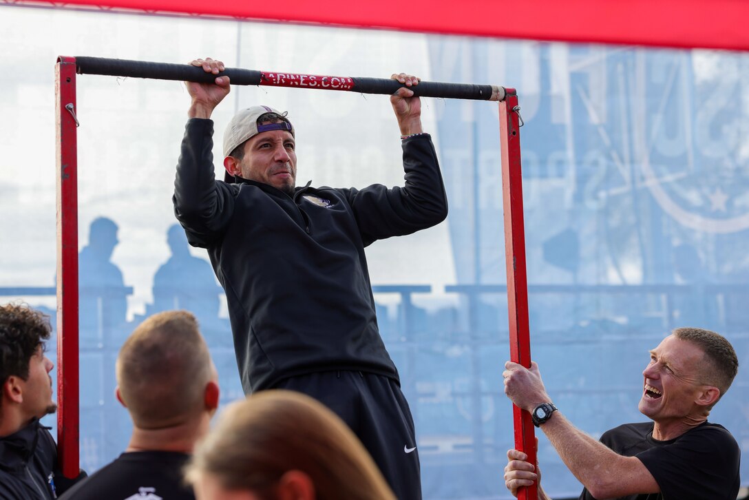 Students attending the National Junior College Athletic Association Cross Country and Half Marathon Championships attempt to participate in the pull up challenge in Huntsville, Al., on November 10, 2023. Throughout the Championship, Marines engaged with coaches and administrators, congratulated the race winners and spread the Marine Corps message. (U.S. Marine Corps photo by Lance Cpl. Brenna Ritchie)