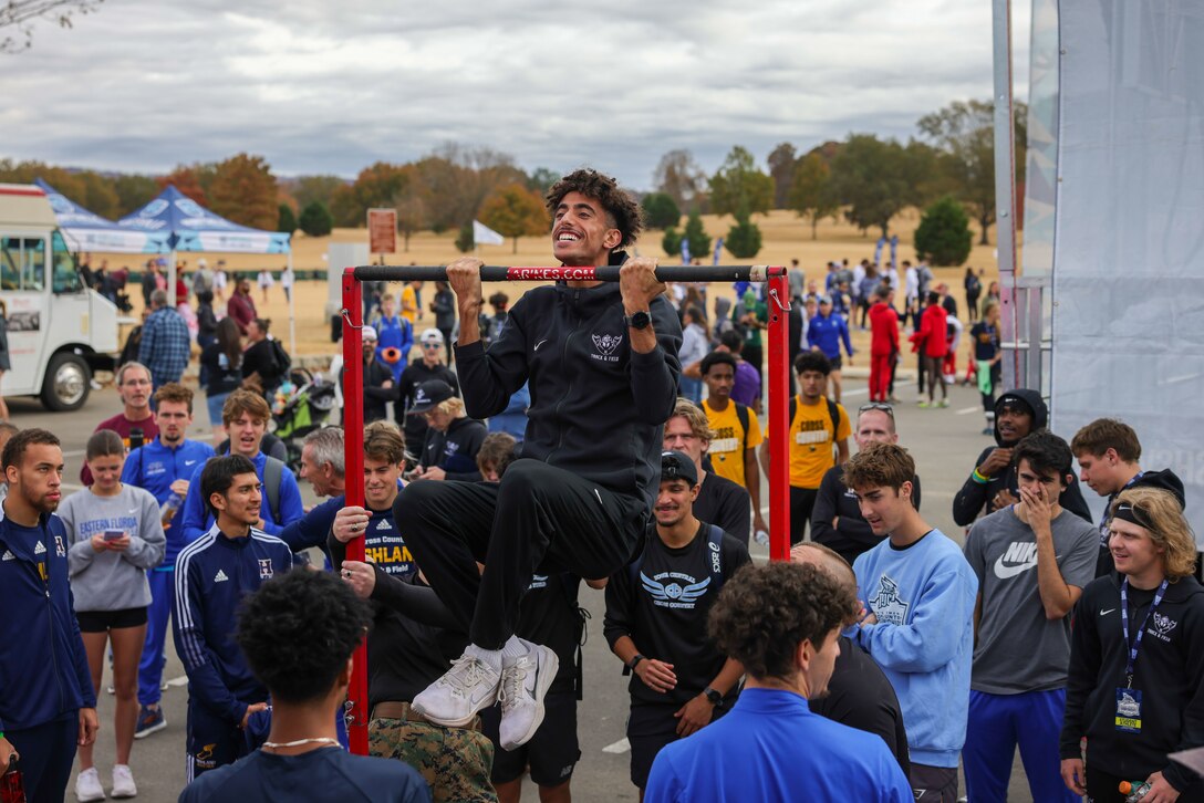 Students attending the National Junior College Athletic Association Cross Country and Half Marathon Championships attempt to participate in the pull up challenge in Huntsville, Al., on November 10, 2023. Throughout the Championship, Marines engaged with coaches and administrators, congratulated the race winners and spread the Marine Corps message. (U.S. Marine Corps photo by Lance Cpl. Brenna Ritchie)