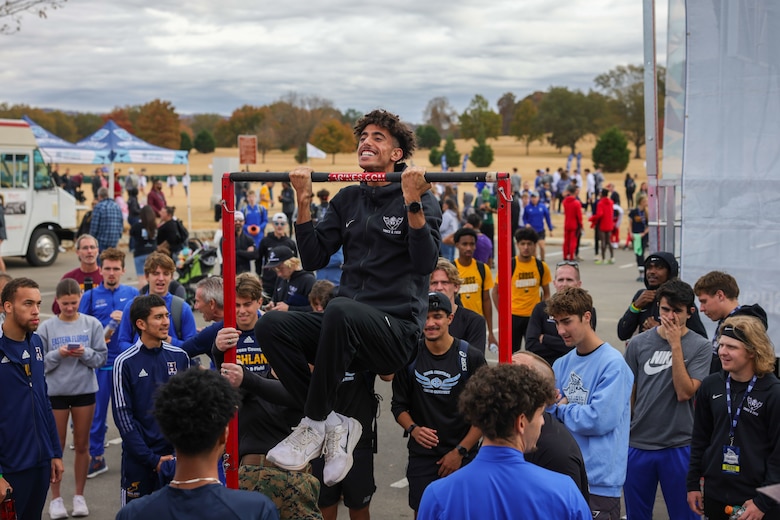 Students attending the National Junior College Athletic Association Cross Country and Half Marathon Championships attempt to participate in the pull up challenge in Huntsville, Al., on November 10, 2023. Throughout the Championship, Marines engaged with coaches and administrators, congratulated the race winners and spread the Marine Corps message. (U.S. Marine Corps photo by Lance Cpl. Brenna Ritchie)
