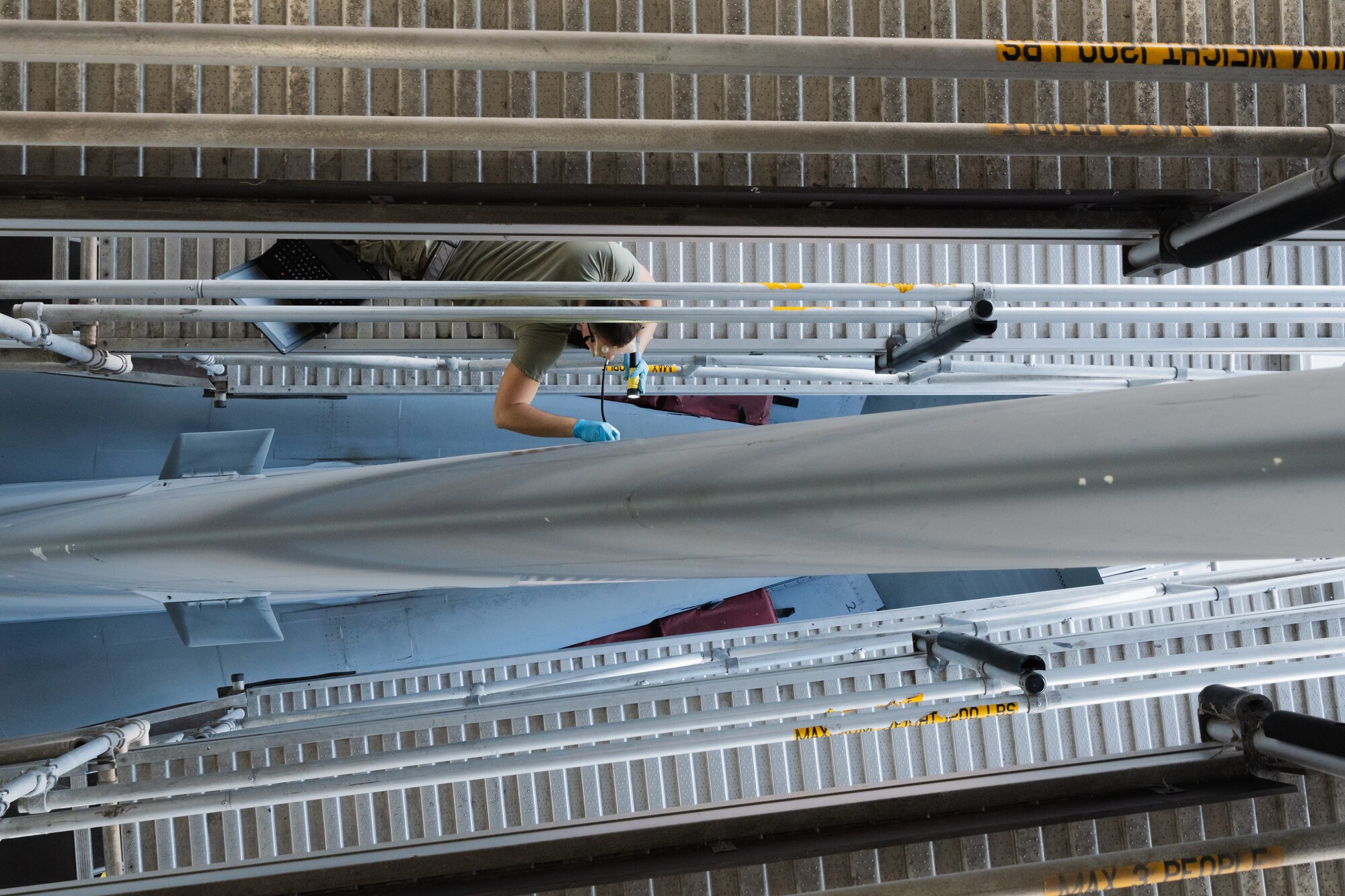 U.S. Air Force Airman Troy Coker, 6th Maintenance Squadron crew chief, administers lubricant to the tail of a KC-135 Stratotanker at MacDill Air Force Base, Florida, Nov. 21, 2023.