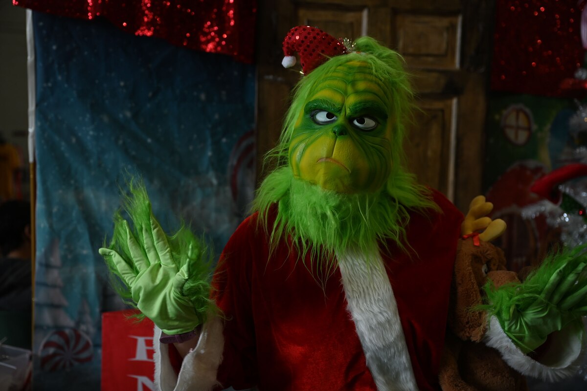A volunteer dressed as the Grinch to take  photos with guests during the 41st Santa’s Market at the Louis F. Garland Department of Defense Fire Academy, Goodfellow Air Force Base, Texas, Nov. 18, 2023. Face painting, arts and crafts, photos with Santa and food were some of the activities offered for participants to enjoy.