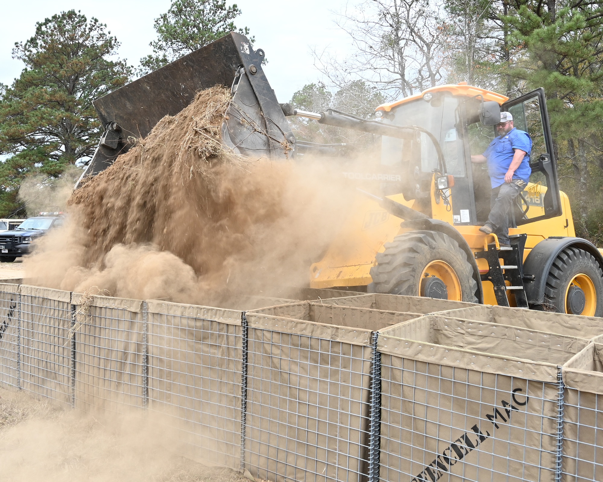 Heavy machinery is used to fill barriers.