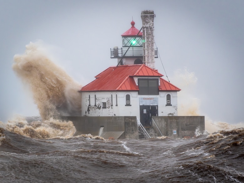 A wave slams against the 1901-built South Pier Outer Breakwater Lighthouse in Duluth, Minnesota during a Lake Superior storm on April 20, 2023. (U.S. Army photo by Scott Bjorklund)