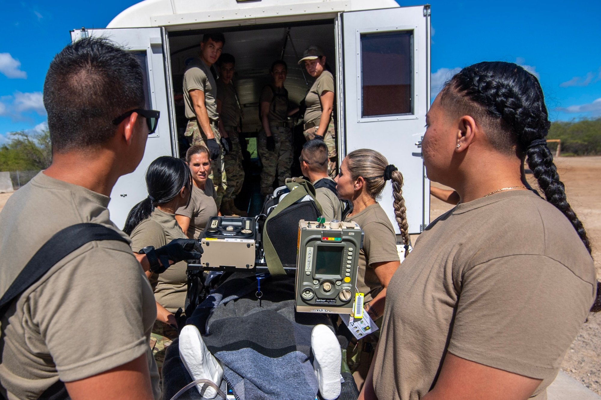 Reserve Citizen Airmen from the 624th Aeromedical Staging Squadron move patients to a medical ambulance bus during En Route Patient Staging System training event, Joint Base Pearl Harbor-Hickam, Nov. 4, 2023