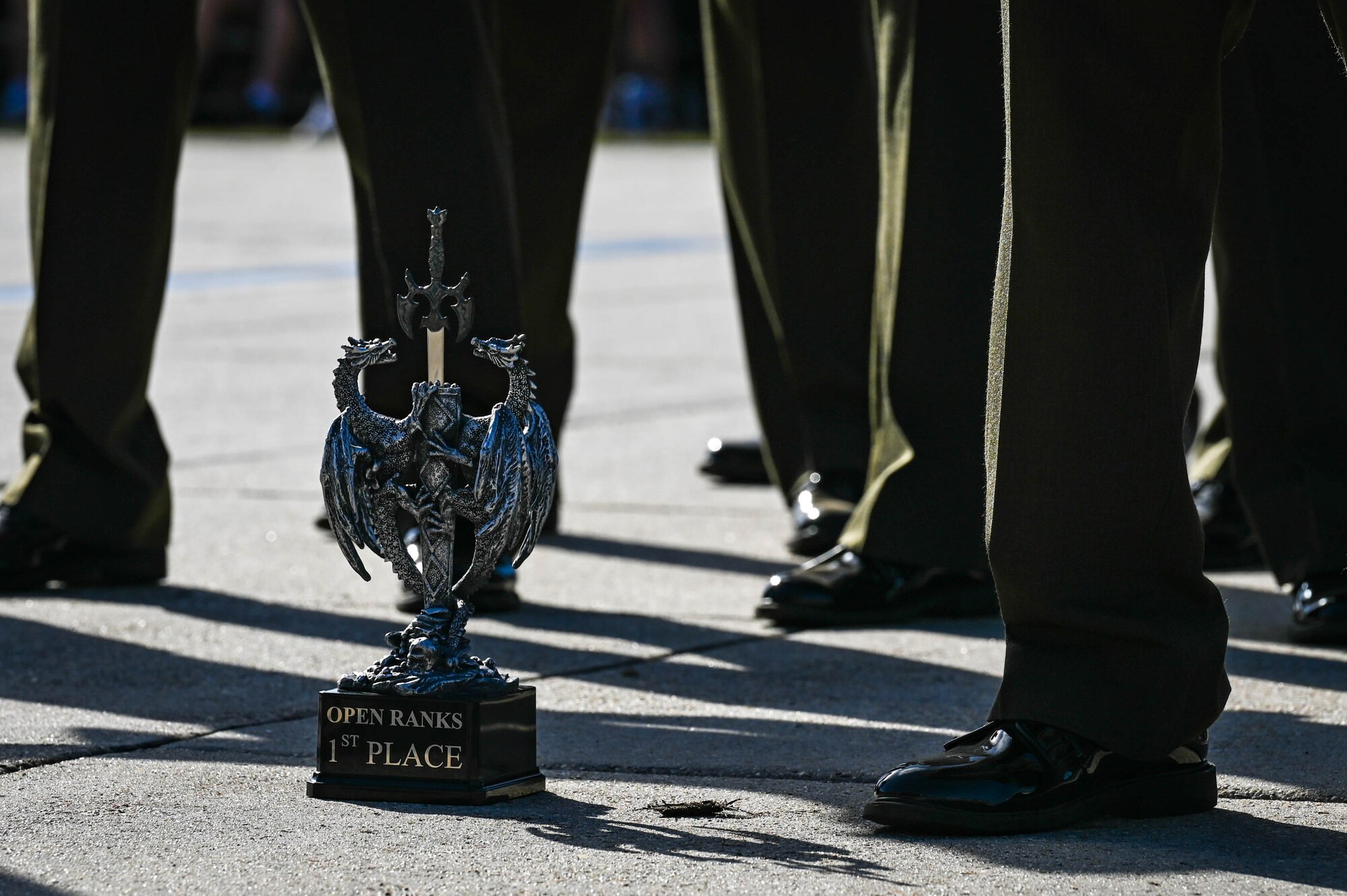 Students from the Keesler Marine Detachment stand with their first place trophy at the Fourth Quarter Drill Down competition at the Levitow Training Support Facility drill pad on Keesler Air Force Base, Mississippi, Oct. 27, 2023.