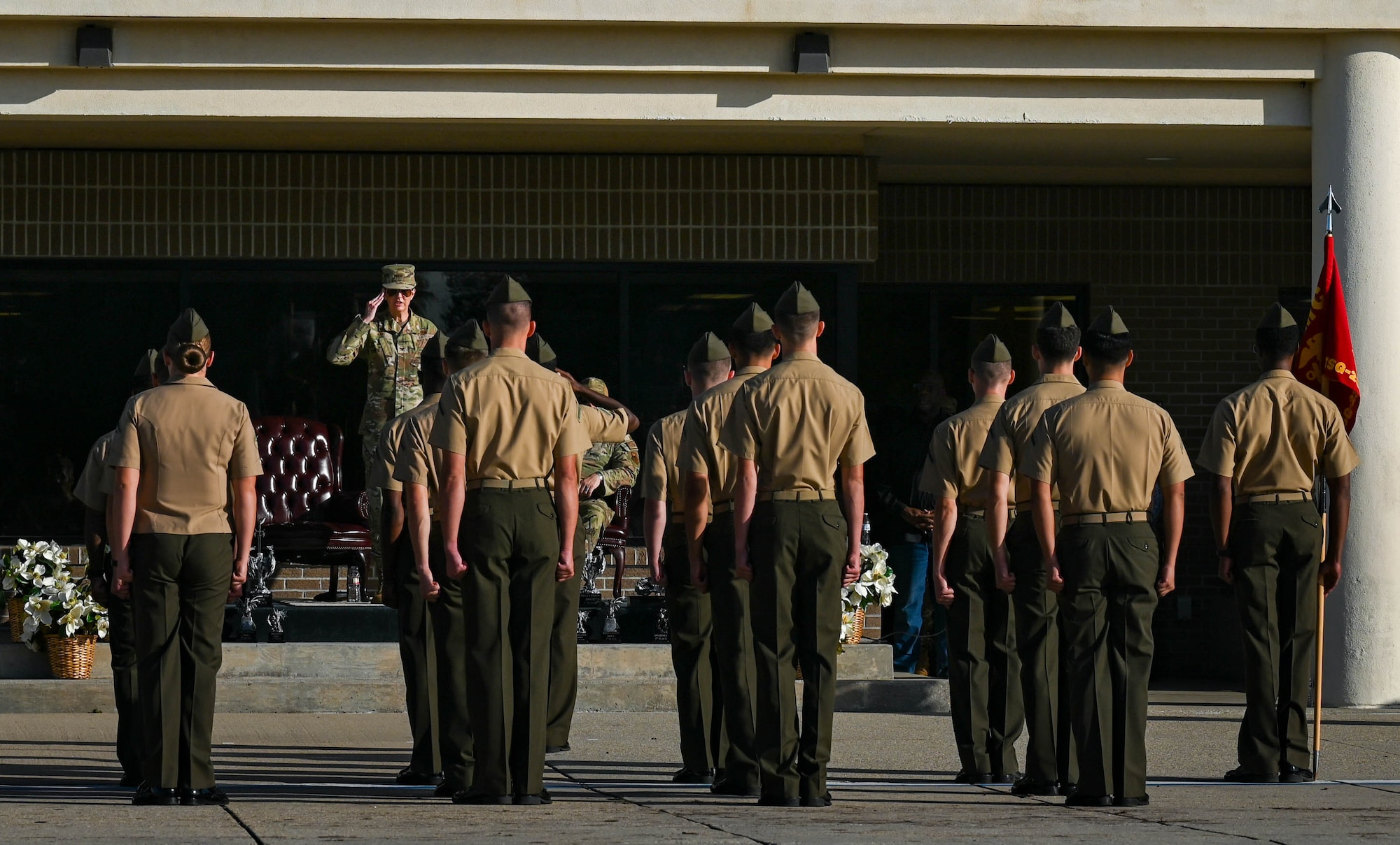 U.S. Air Force Col. Laura King, 81st Training Group commander, returns a salute to Keesler Marine Detachment students, signaling the beginning of their regulation drill performance at the Fourth Quarter Drill Down competition at the Levitow Training Support Facility drill pad on Keesler Air Force Base, Mississippi, Oct. 27, 2023.