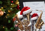 Image of a Christmas tree, sheet of music, instruments, Santa Hat, and holiday garland.