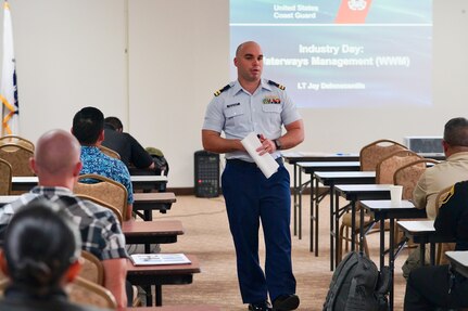 Lt. jay DeInnocentiis discusses waterways management with participants of the U.S. Coast Guard Forces Micronesia/Sector Guam hosted second annual Industry Day on Nov. 20, 2023, in Guam. Following the success of the inaugural session in 2022, this event further strengthened the collaboration between the U.S. Coast Guard and the maritime industry. The day's agenda included insightful presentations and discussions led by U.S. Coast Guard officials and industry experts. Topics ranged from domestic vessel inspection and maritime cybersecurity to modernization updates from the Port of Guam. This Industry Day is significant for the U.S. Coast Guard and the maritime industry. It provides a unique platform for a mutual exchange of ideas and challenges, helping to build a stronger, more informed maritime community. (U.S. Coast Guard photo by Chief Warrant Officer Sara Muir)