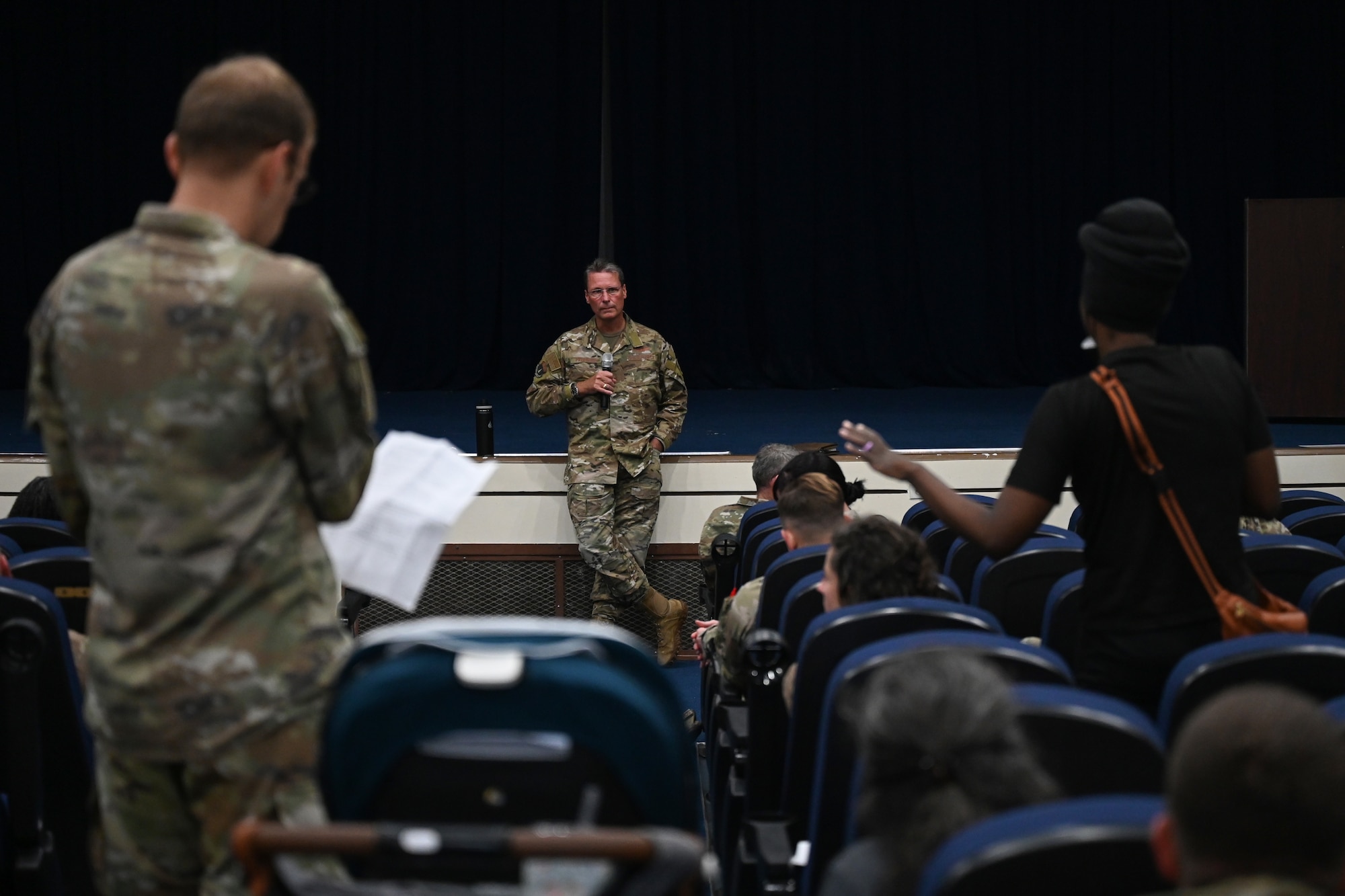 U.S. Air Force Brig. Gen. Thomas Palenske, 36th Wing commander, listens to a member of Team Andersen ask a question during a townhall event at Andersen Air Force Base, Guam, Nov. 17, 2023.