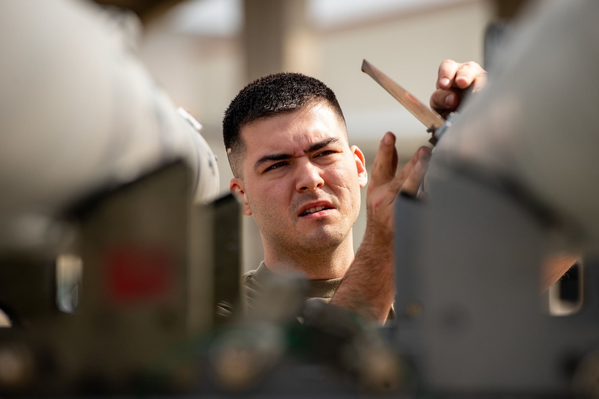 An Airman from the 18th Aircraft Maintenance Squadron prepares an AIM-120 Advanced Medium Range Air-to-Air Missile to be loaded onto an F-15C Eagle during a weapons load competition at Kadena Air Base, Japan, Nov. 17, 2023. Kadena’s aircraft weapons load teams face off quarterly to test the skill and professionalism of Kadena Airmen while building camaraderie among the base’s diverse team of aircraft maintainers. (U.S. Air Force Photo by Lt. Col. Raymond Geoffroy)
