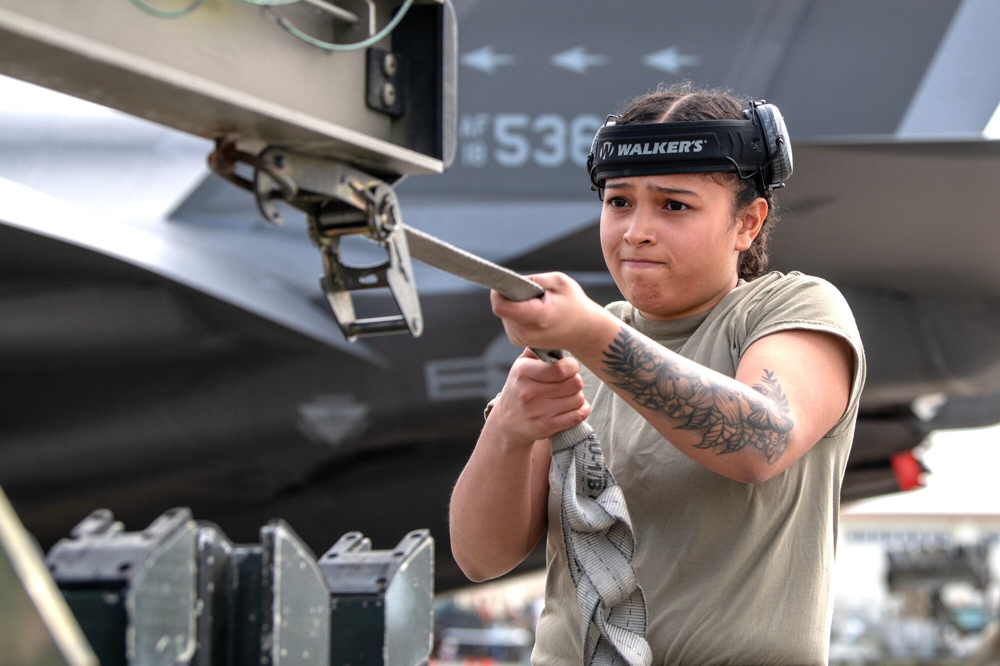 An Airman assigned to the 356th Fighter Generation Squadron fastens the straps on a bomb rack during a weapons load competition at Kadena Air Base, Japan, Nov. 17, 2023. The 356th FGS is deployed to Kadena to support deployed F-35As that are maintaining U.S. fifth-generation fighter presence in and around Japan’s south-west islands. (U.S. Air Force Photo by Staff Sgt. Jessi Roth)