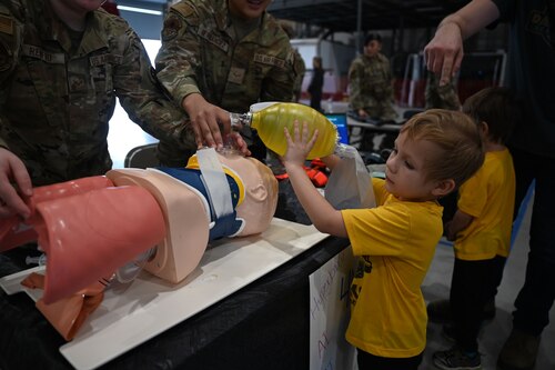 U.S. Air Force Airman 1st Class Alexis Hernandez and Senior Airman Meagen Renfro, 17th Healthcare Operations Squadron aerospace medical technicians, demonstrate to young participants how a manual resuscitator works during the 41st Santa’s Market at the Louis F. Garland Department of Defense Fire Academy, Goodfellow Air Force Base, Texas, Nov. 18, 2023. Santa’s Market invited the community on base to learn more about Goodfellow's mission.
